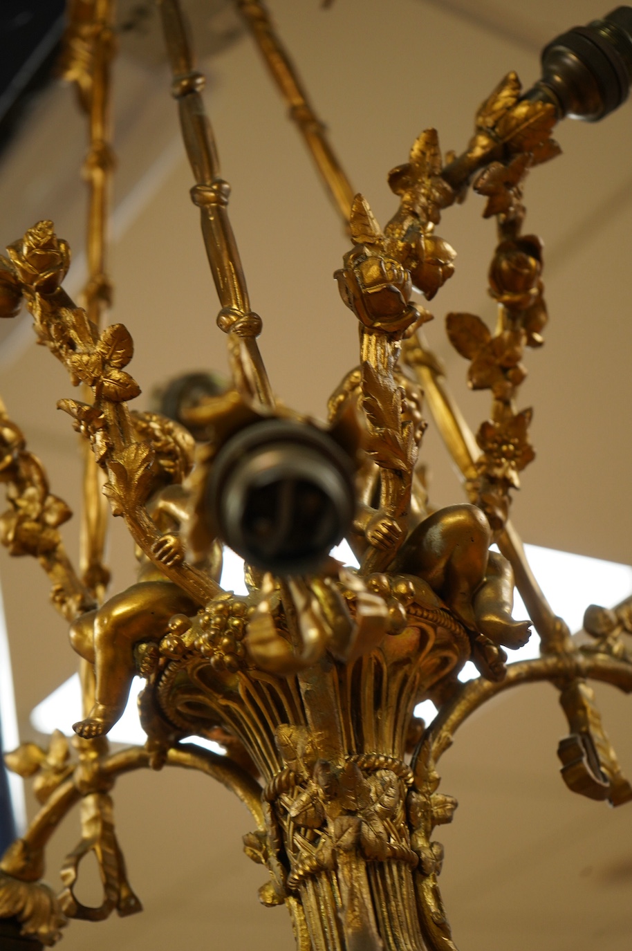 A gilt metal chandelier in the form of a cherub in a basket, 65cm high. Condition - fair, untested
